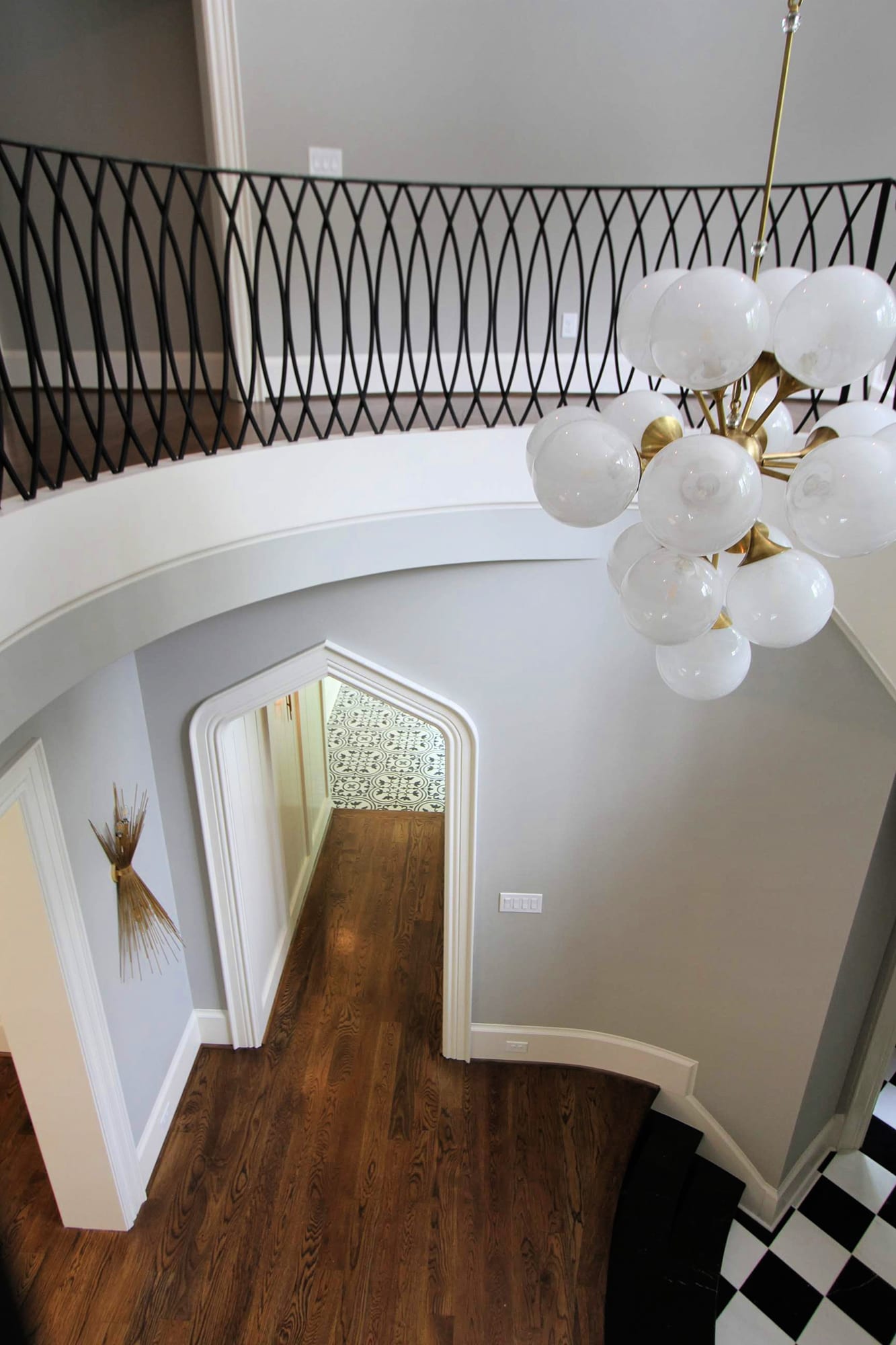 Transitional Rambler, circular, marble stairs, bubble light foyer, custom iron railing